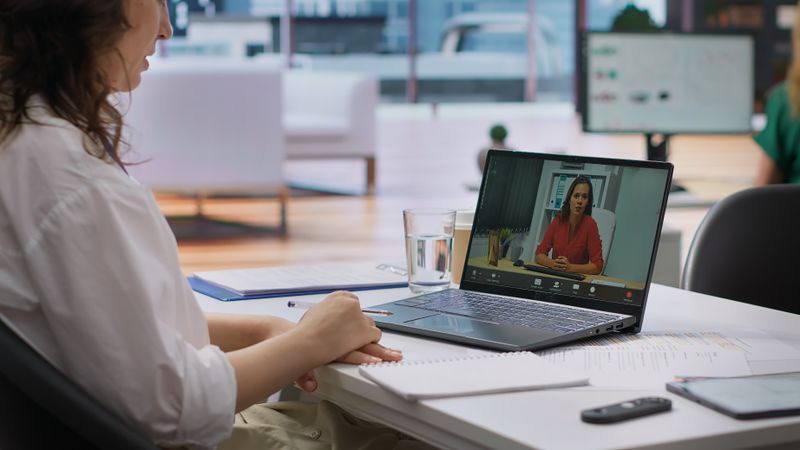 Human resources worker conducting a job interview via online videocall, using remote internet connection