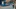 Image of people waiting for tram in city street and man cycling on cycle path