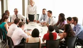 Group of people sitting around a table at the office
