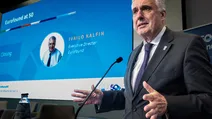 Man speaking at a podium with a presentation slide behind him showing "Eurofound at 50" and "Ivailo Kalfin, Executive Director, Eurofound."